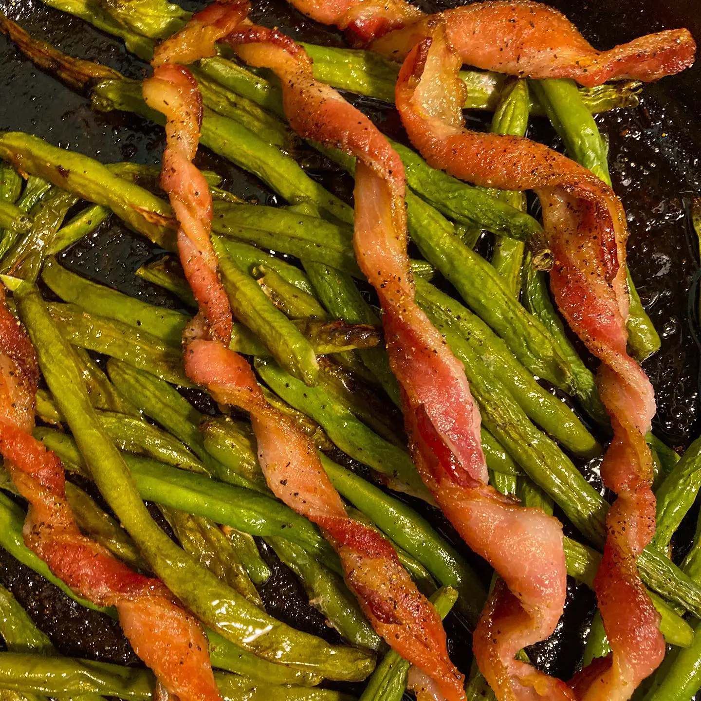 I don’t always do tik tok trends but when I do it’s because I have the ingredients already in my fridge. 
.
.
Let me tell you the spiral bacon hack is actually really great ESPECIALLY when you: toss green beans in a lil olive oil, lay them down in a skillet,
top with the spiral bacon, season everything with salt and pepper, and then roast at 400° degrees for 30-40 minutes! The green beans are flavored and you end up with these yummy bacon “fries” to serve on the side. It’s just darn good.
.
.
.
.
.
.
.
.
#bacon #baconlovers #tiktoktrending #homecooking #foodiesfeed #instaeats #instayum #foodblogger #foodpic #dailyfoodfeed #heresmyfood #igfood #thekitchn #feedfeed #blackfoodie #blackfoodbloggers #eeeeeats #sidedish #easyrecipes #foodporn